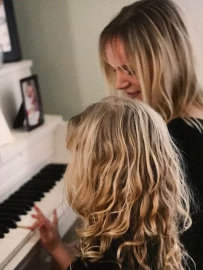 mother and daughter sitting at the piano