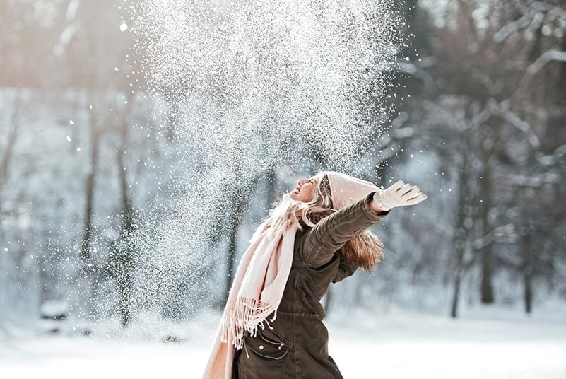 woman joyful in winter snow