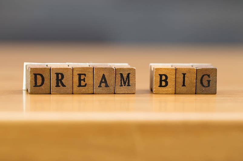 Scrabble cubes spelling out the words "dream big"