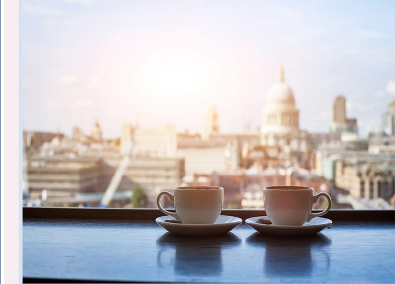 pink coffee cups with view of London