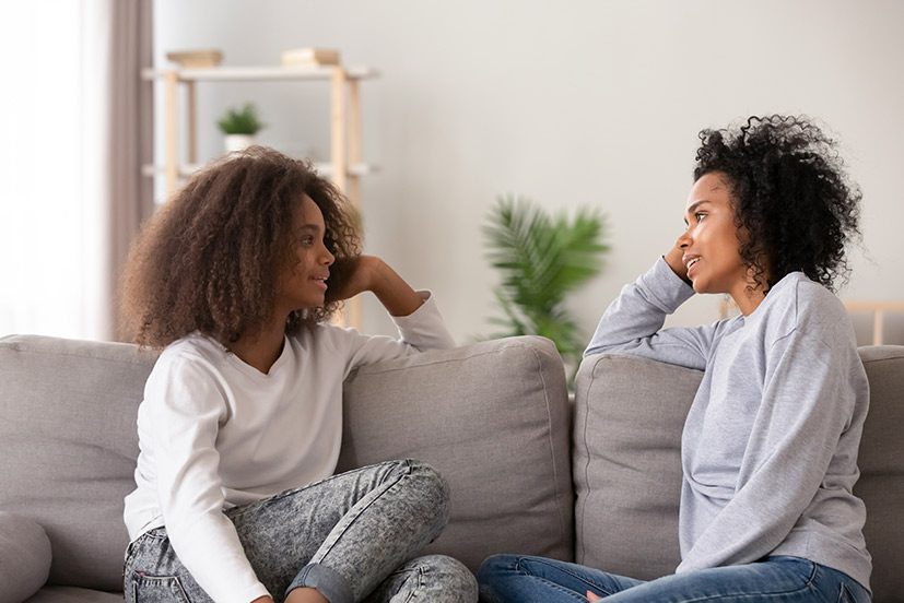 two women talking - one listening. Effective listening matters. You can build strong relationships by utilizing nonverbal clues and paying attention.