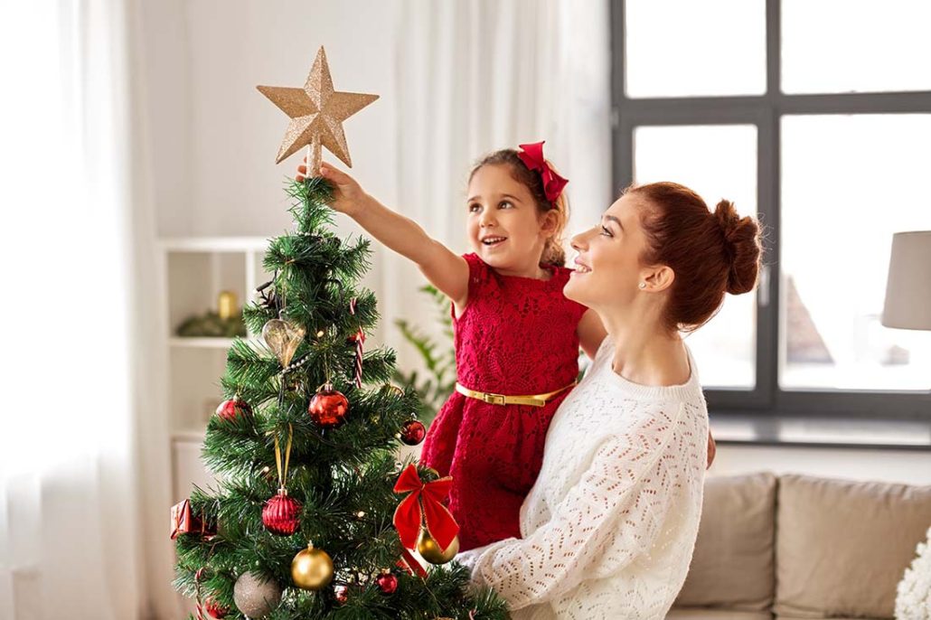 gratitude woman decorating tree with child
