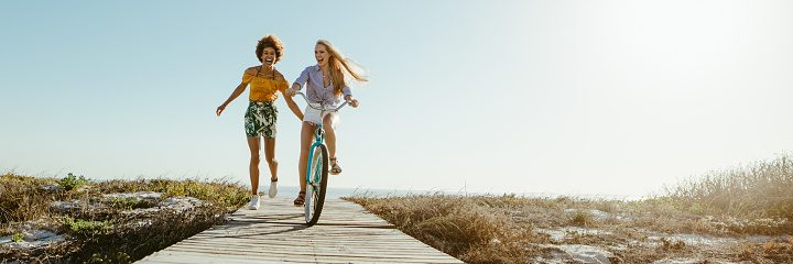 Two young women on bikes - happy and free!