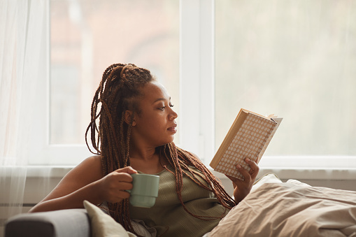 woman slowing down, reading a book