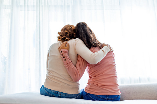 Two women hugging. Vulnerability. "I'm sorry I'm not a perfect mother." Needing support.