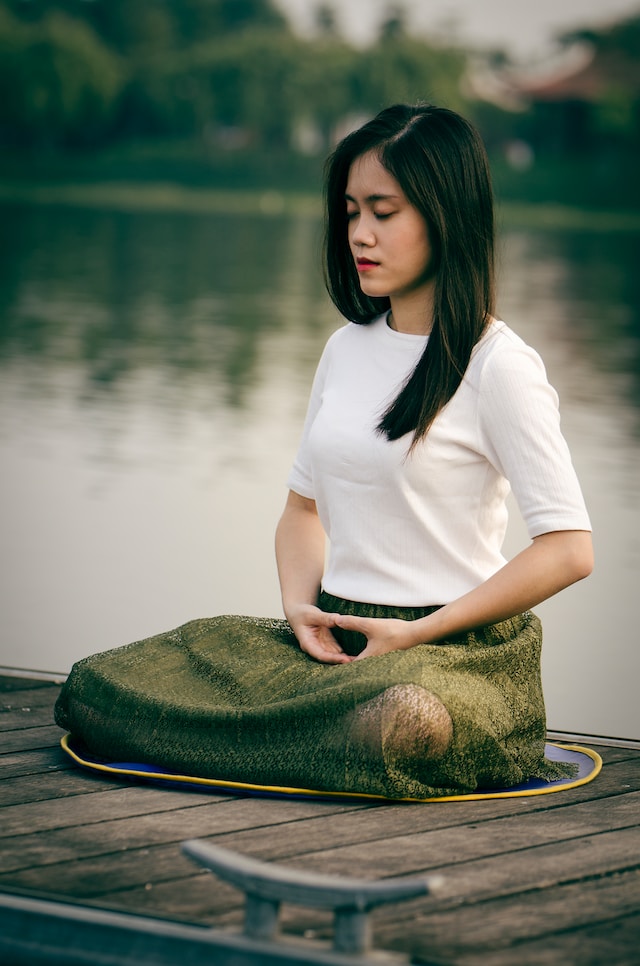 A woman meditating - attempting to protect her energy.