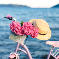 Slow living. Pink bicycle by the sea.